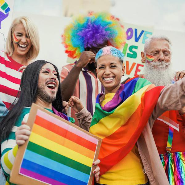 People from different generations have fun at gay pride parade with banner - Lgbt and homosexual love concept